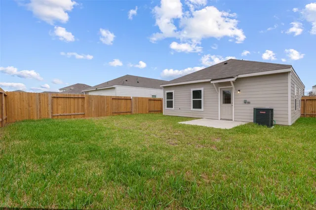 a view of a yard in front of a house with a garden