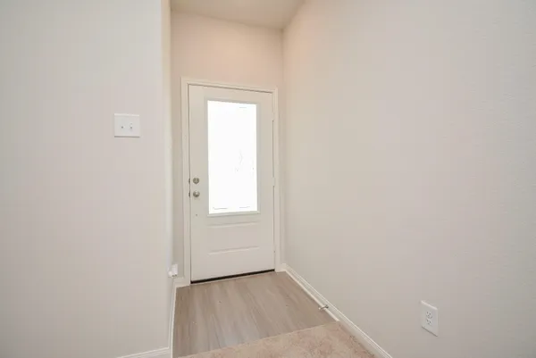 a view of an empty room with closet and a window