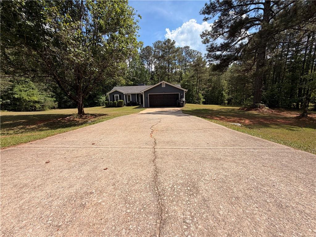 145 Stoneview Circle Covington, GA 30016 - Photo 14 of 41 a view of a house with a yard and large trees