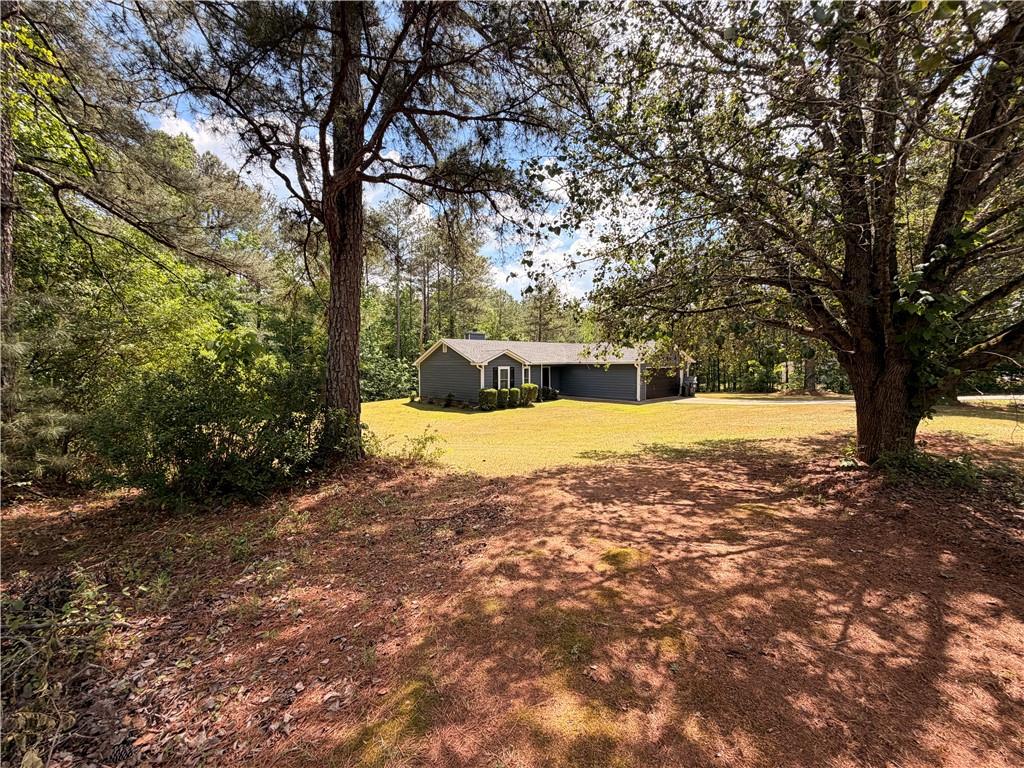 145 Stoneview Circle Covington, GA 30016 - Photo 16 of 41 a view of a yard with a tree
