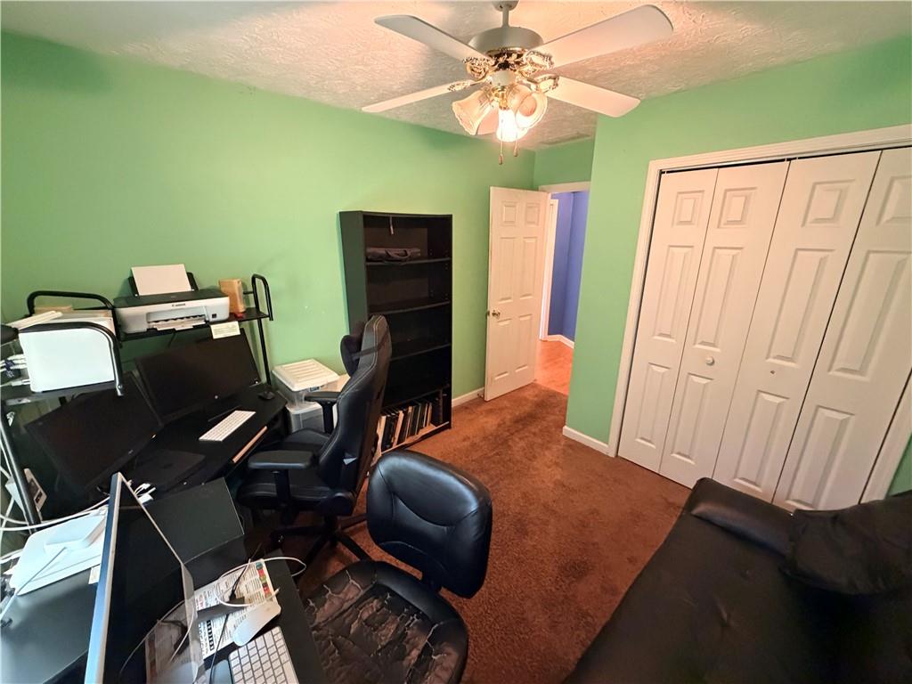 145 Stoneview Circle Covington, GA 30016 - Photo 18 of 41 a workspace with furniture and a chandelier