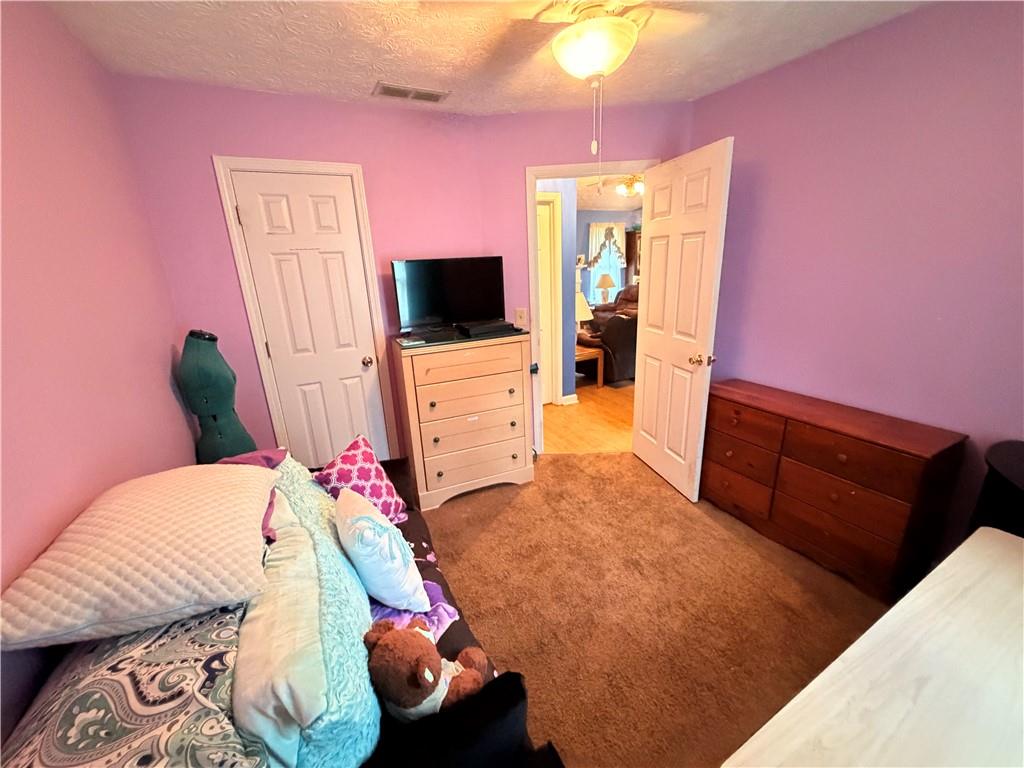 145 Stoneview Circle Covington, GA 30016 - Photo 22 of 41 a bedroom with furniture and a flat screen tv