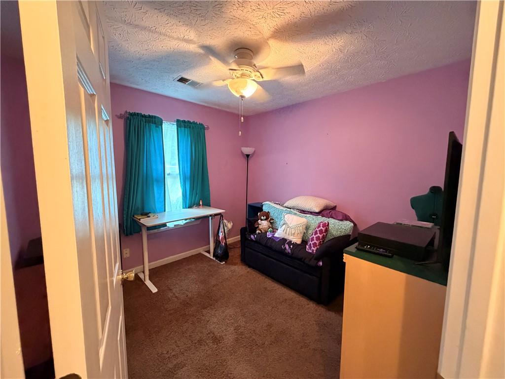 145 Stoneview Circle Covington, GA 30016 - Photo 23 of 41 a bedroom with furniture and a flat tv screen