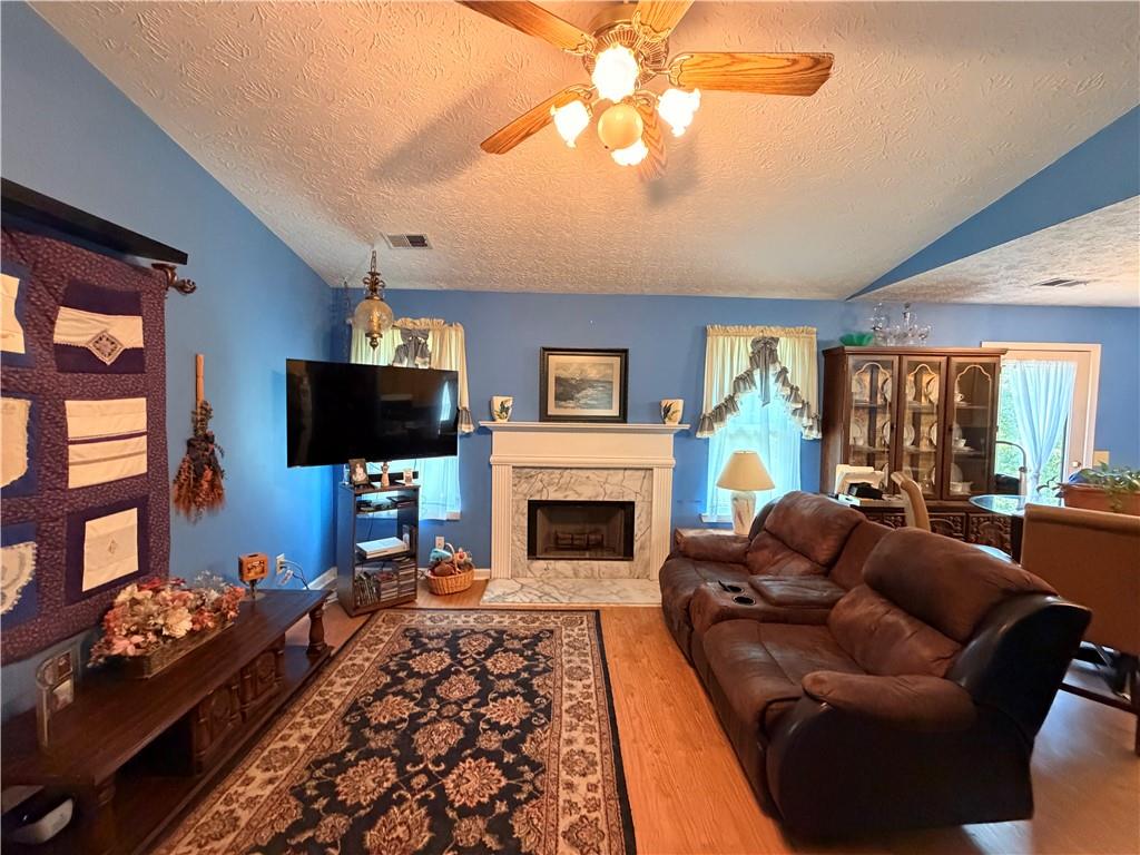 145 Stoneview Circle Covington, GA 30016 - Photo 28 of 41 a living room with furniture a flat screen tv and a fireplace