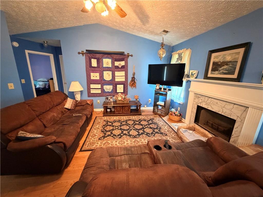 145 Stoneview Circle Covington, GA 30016 - Photo 29 of 41 a living room with furniture and a flat screen tv