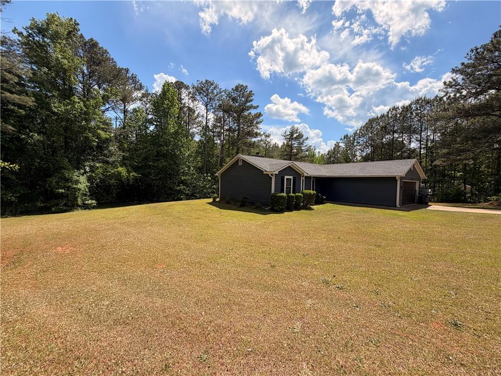 145 Stoneview Circle Covington, GA 30016 - Photo 3 of 41 a front view of a house with a yard