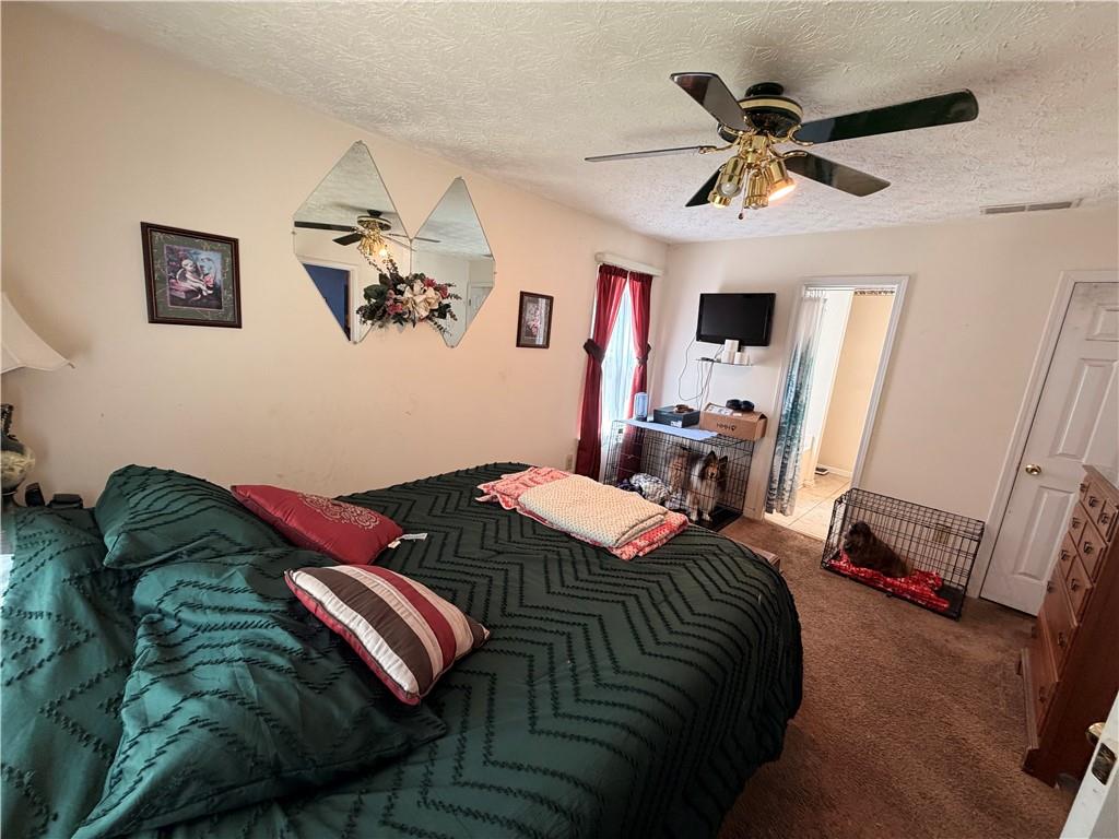145 Stoneview Circle Covington, GA 30016 - Photo 37 of 41 a bedroom with a bed and wooden floor