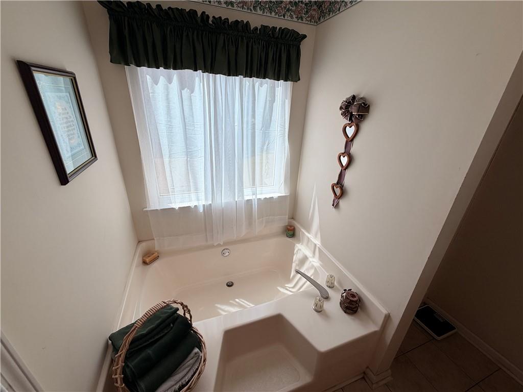 145 Stoneview Circle Covington, GA 30016 - Photo 39 of 41 a bathroom with a bathtub and shower