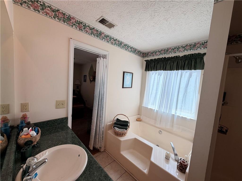 145 Stoneview Circle Covington, GA 30016 - Photo 40 of 41 a bathroom with a sink toilet and shower