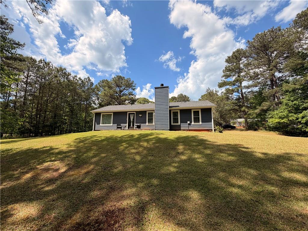 145 Stoneview Circle Covington, GA 30016 - Photo 8 of 41 a front view of a house with a garden