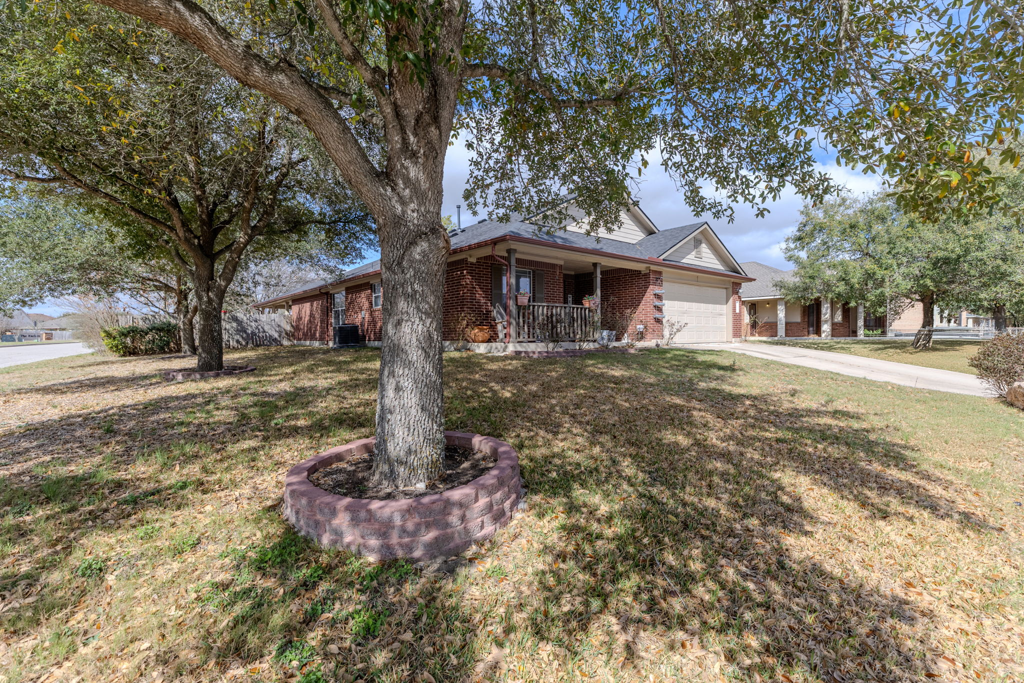 12800 Starbrimson Trail Elgin, TX 78621 - Photo 1 of 19 a front view of a house with a yard and large trees