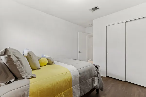 a bedroom with a bed and a closet