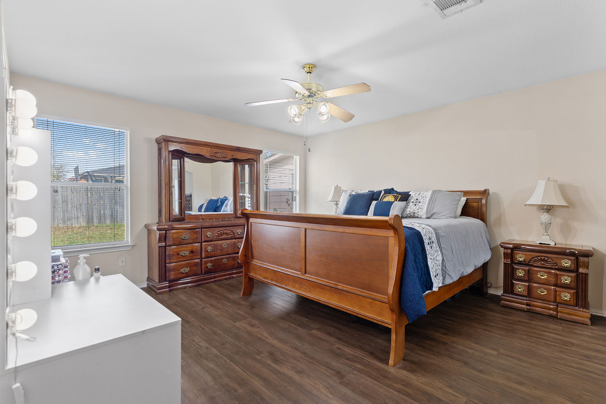 12800 Starbrimson Trail Elgin, TX 78621 - Photo 14 of 19 a bedroom with a bed and a dresser with mirror