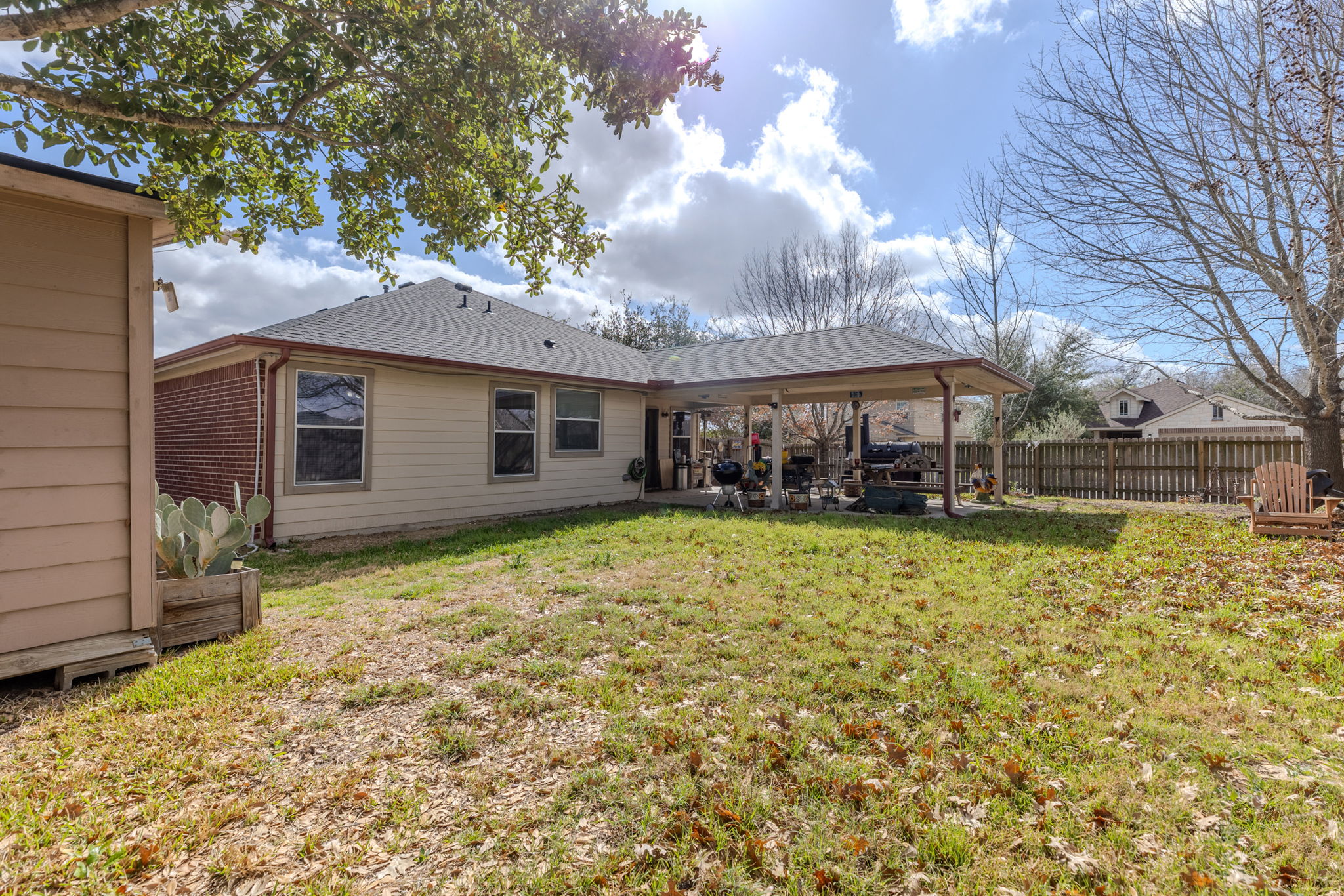 12800 Starbrimson Trail Elgin, TX 78621 - Photo 17 of 19 a view of a house with a large tree and a yard