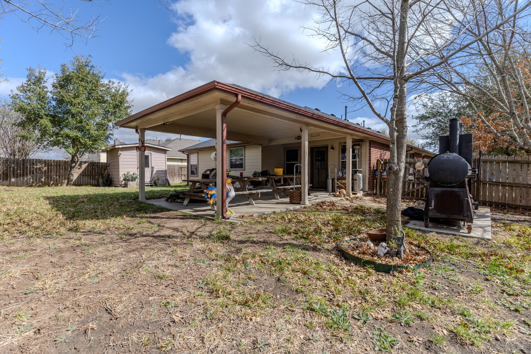 12800 Starbrimson Trail Elgin, TX 78621 - Photo 18 of 19 a view of a house with backyard porch and sitting area