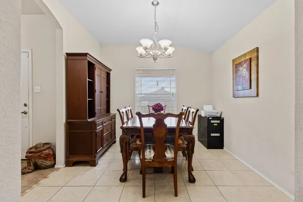a view of a dining room with furniture and chandelier