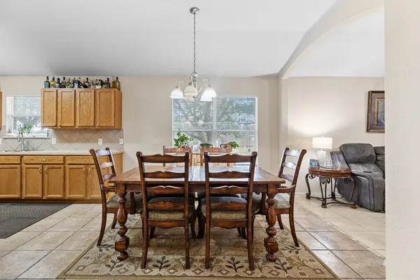 a view of a dining room with furniture and chandelier