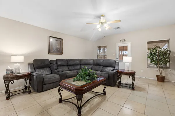 a living room with furniture and a chandelier