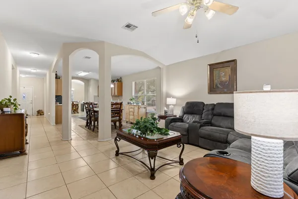 a living room with furniture and a chandelier