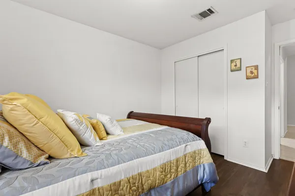 a bedroom with a bed and with wooden floor