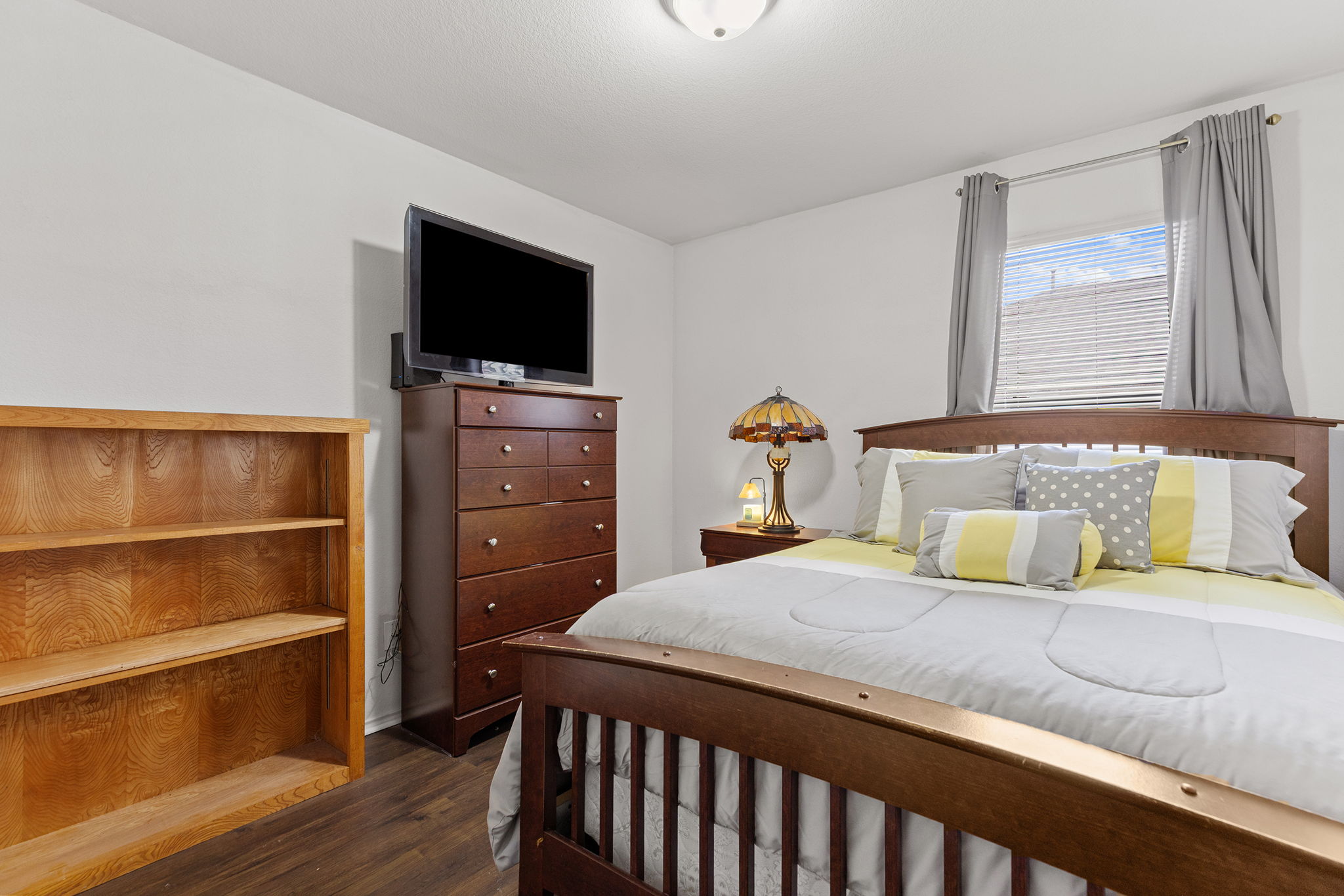 12800 Starbrimson Trail Elgin, TX 78621 - Photo 10 of 19 a bedroom with a bed and a flat screen tv