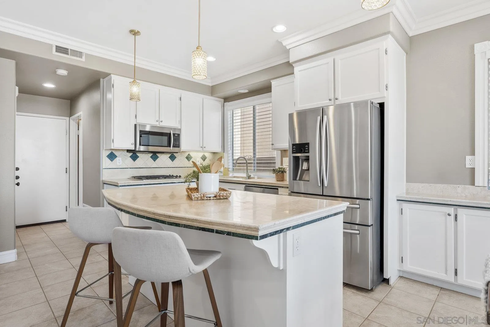 11542 Village Ridge Road San Diego, CA 92131 - Photo 15 of 42 a kitchen with kitchen island a stove a refrigerator a sink and chairs