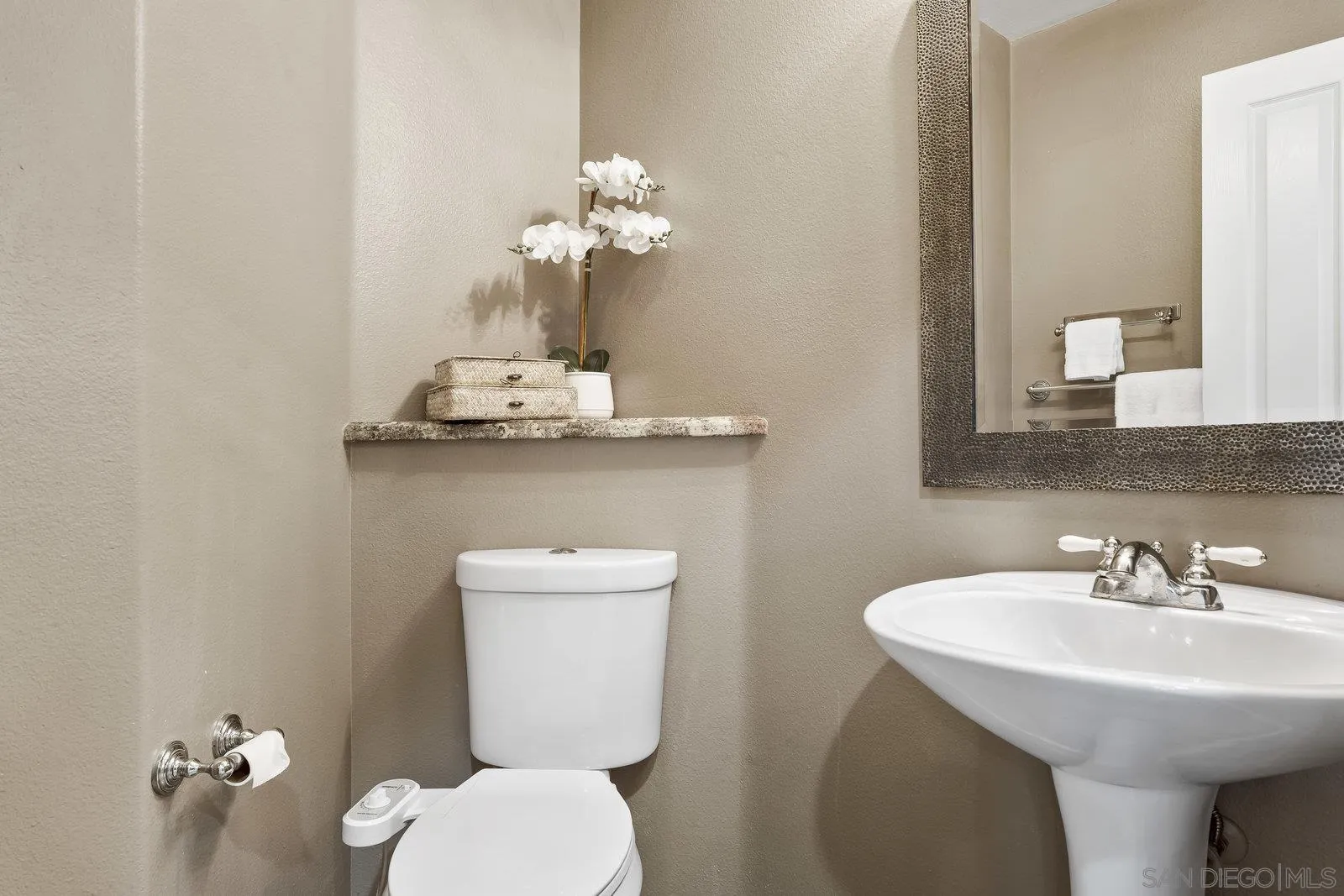 11542 Village Ridge Road San Diego, CA 92131 - Photo 17 of 42 a bathroom with a toilet sink and mirror