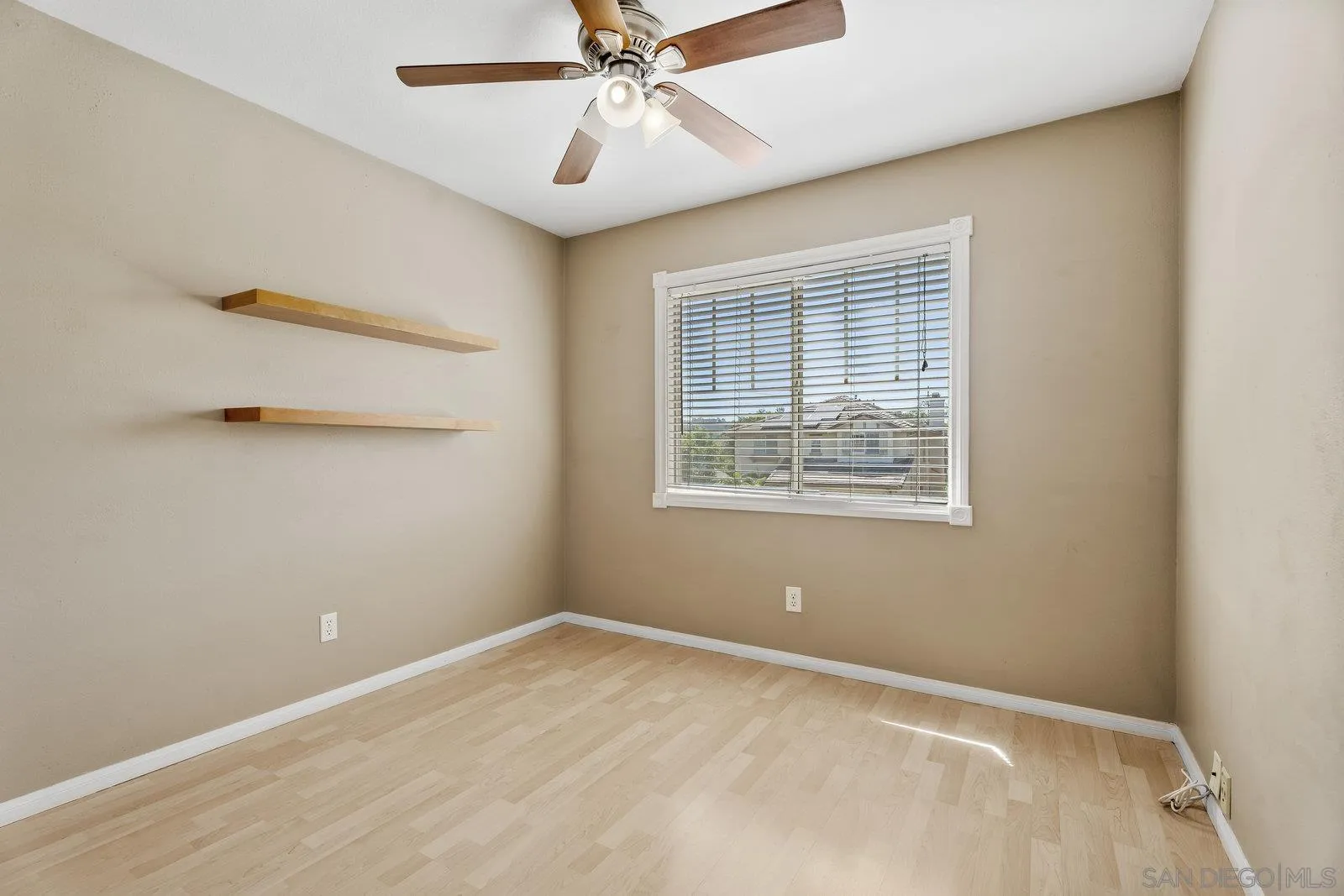 11542 Village Ridge Road San Diego, CA 92131 - Photo 30 of 42 an empty room with a window and a fan