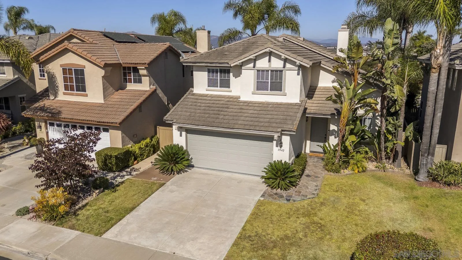 11542 Village Ridge Road San Diego, CA 92131 - Photo 36 of 42 a front view of a house with a yard