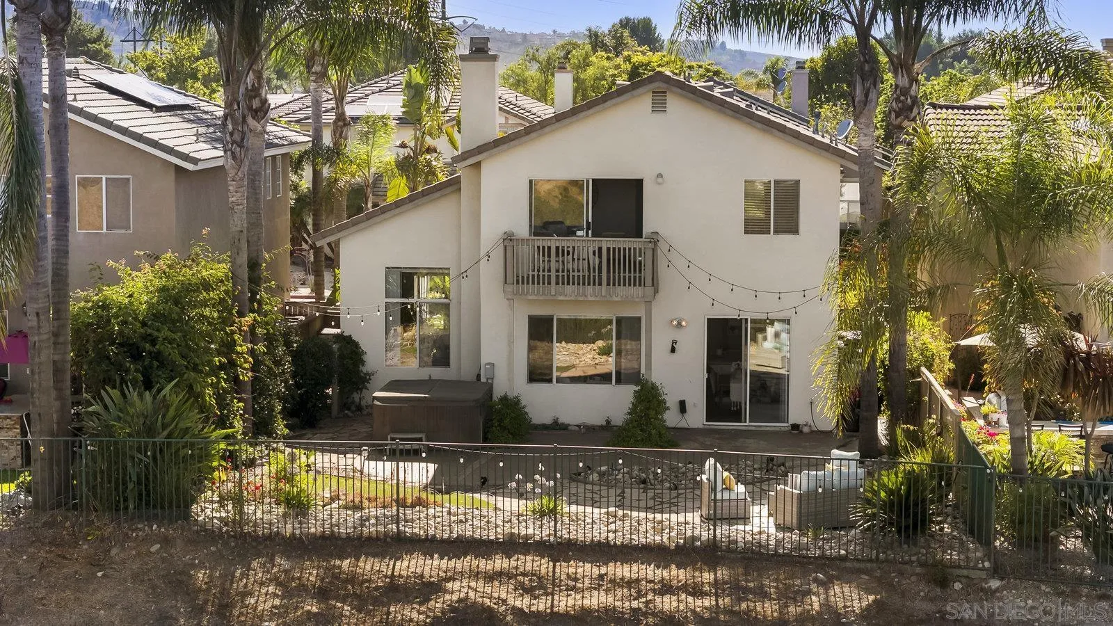 11542 Village Ridge Road San Diego, CA 92131 - Photo 42 of 42 a view of a white house next to a yard with plants and trees