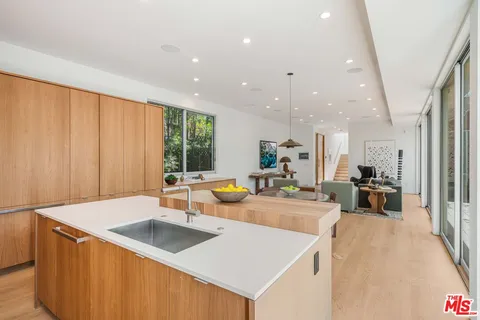 a view of washer and dryer with kitchen in the background