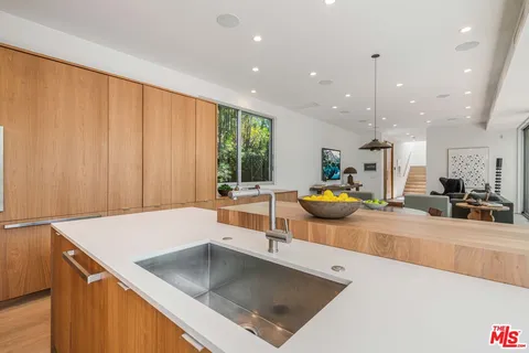 a dining area with furniture and a large window