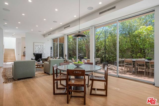 a living room with furniture and a floor to ceiling window