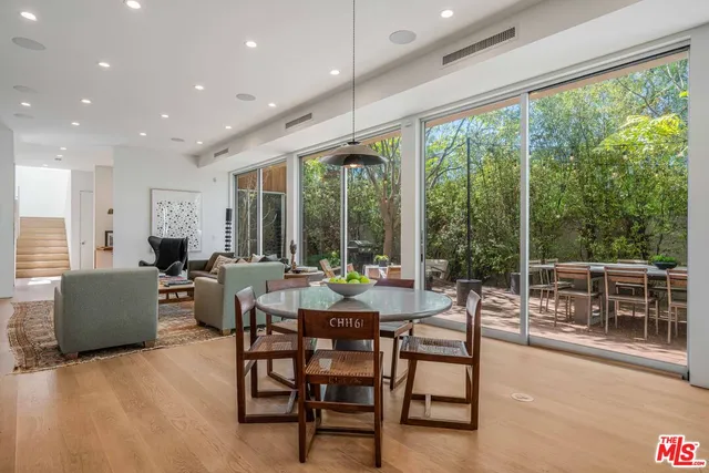 a living room with furniture and a floor to ceiling window