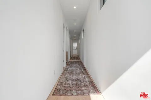 a bedroom with a bed and a view of balcony