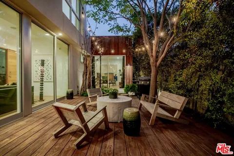 a view of a chairs and table on the wooden deck