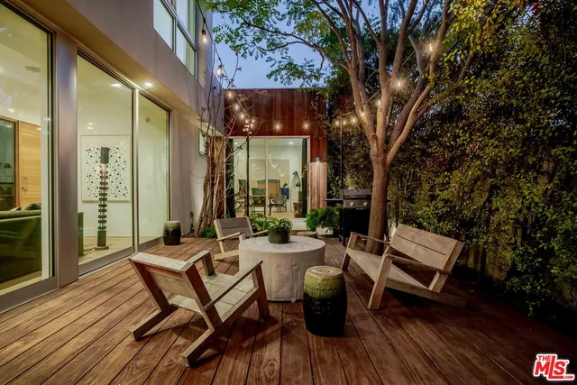 a view of a chairs and table on the wooden deck