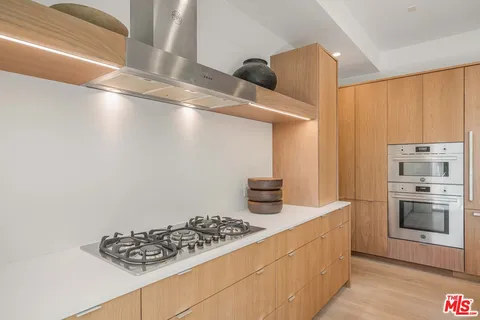 a kitchen with counter top space and appliances