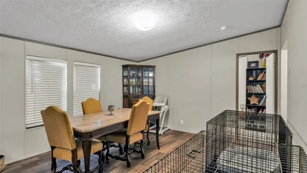 a dining room with furniture and window