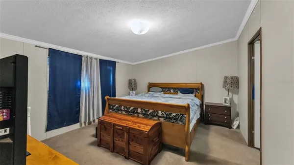 a bedroom with a bed and a night stand