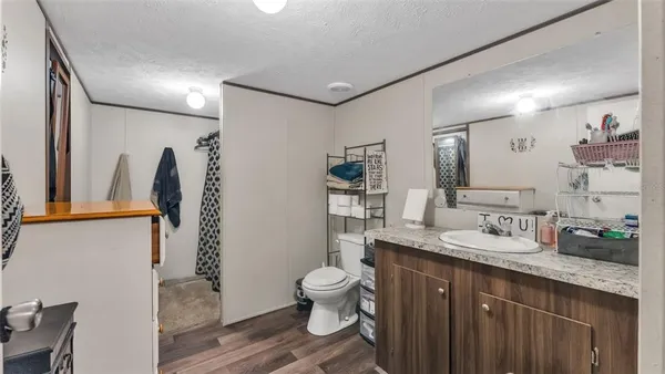 a bathroom with a granite countertop sink toilet and shower