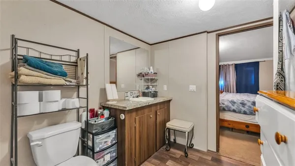 a bathroom with a granite countertop sink a toilet and a shower