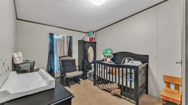 a bedroom with furniture and a window