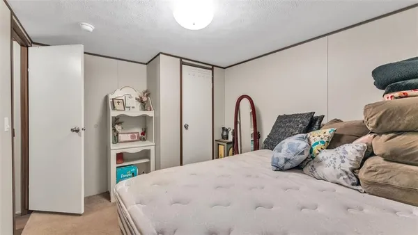 a bedroom with a bed and a large mirror