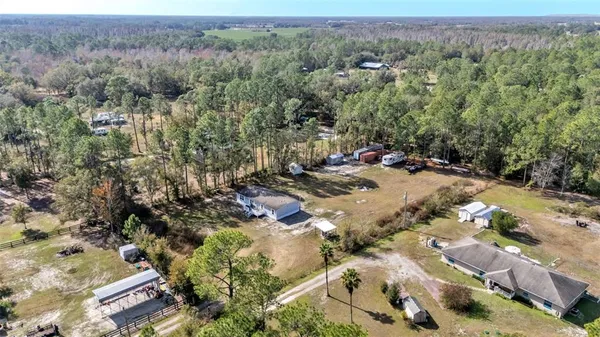 an aerial view of a house with a yard