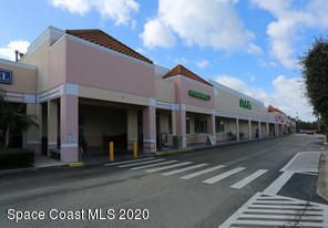 7777 North Wickham Road, Unit 16 A & B Melbourne, FL 32940 - Photo 1 of 1 a front view of a building with a street