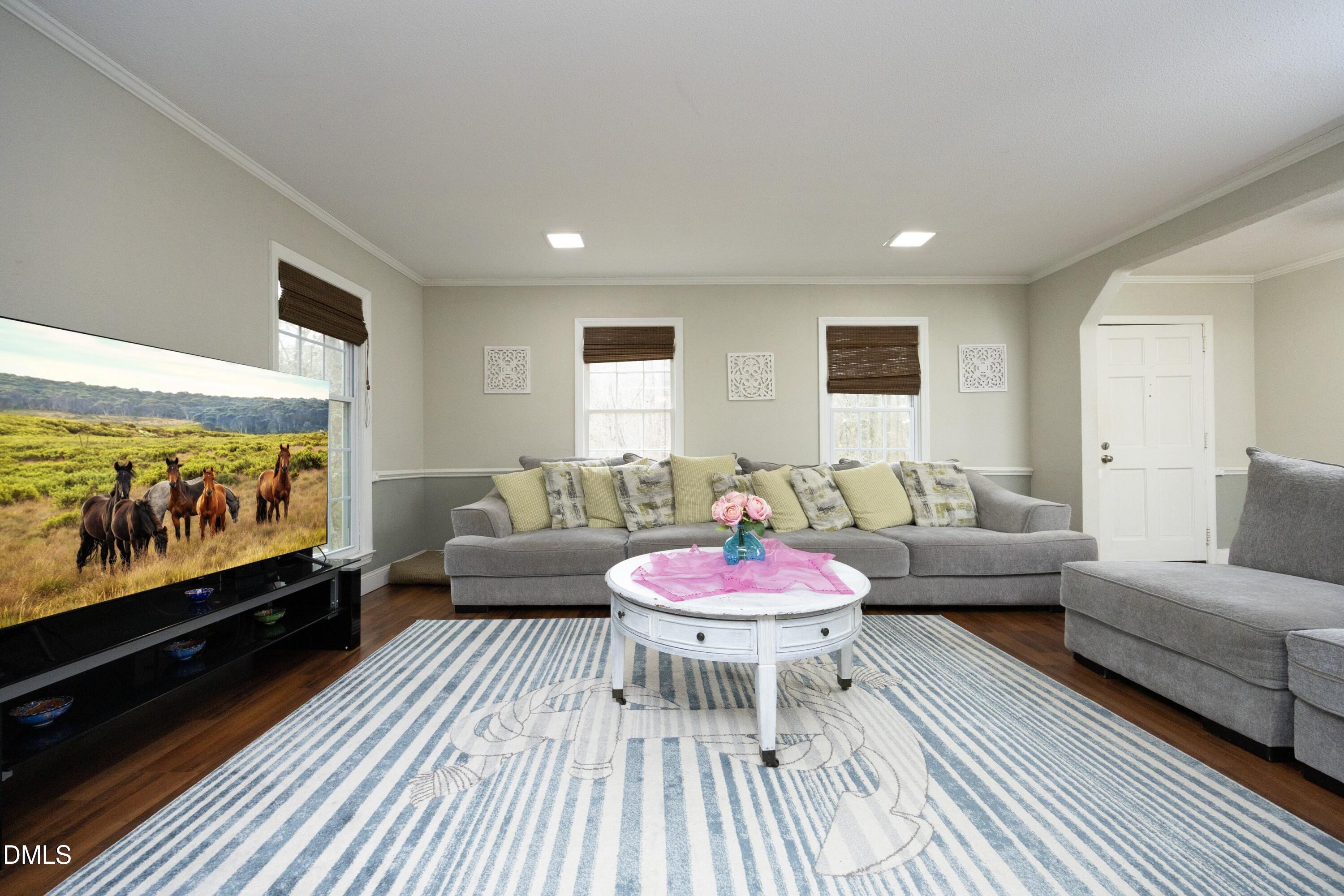 7117 Sunset Lake Road Fuquay-Varina, NC 27526 - Photo 11 of 41 a living room with furniture and a flat screen tv