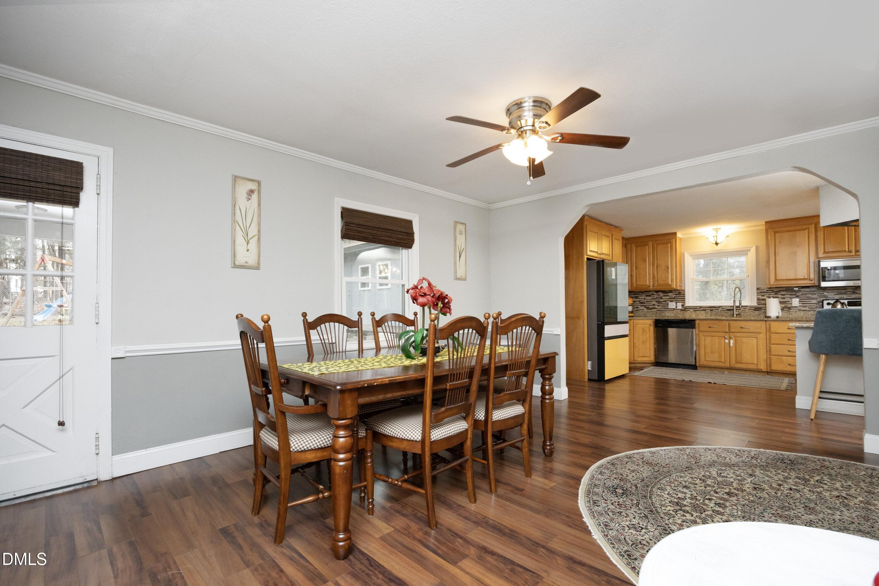 7117 Sunset Lake Road Fuquay-Varina, NC 27526 - Photo 13 of 41 a view of a dining room with furniture and wooden floor
