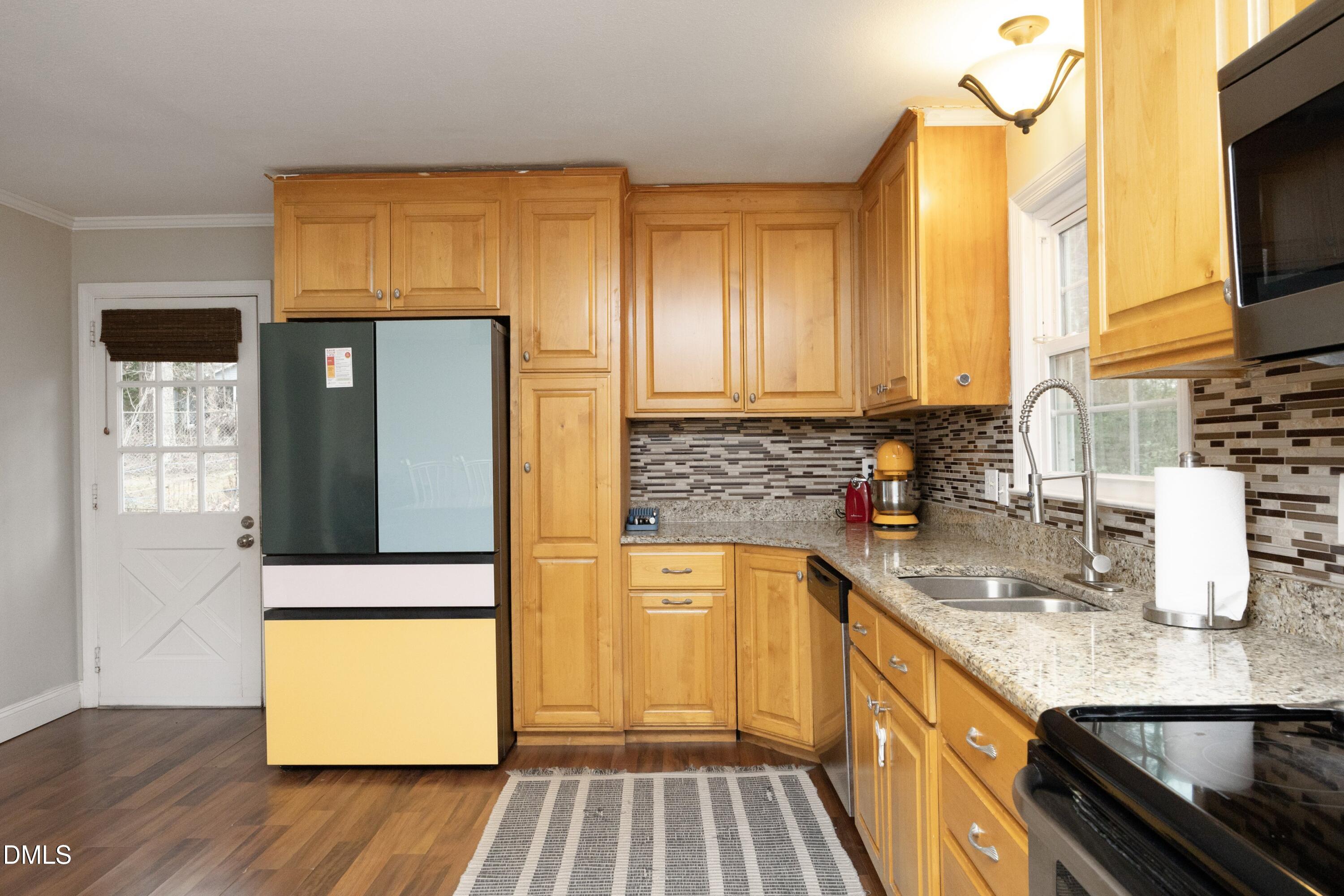 7117 Sunset Lake Road Fuquay-Varina, NC 27526 - Photo 16 of 41 a kitchen with stainless steel appliances granite countertop a sink and a stove