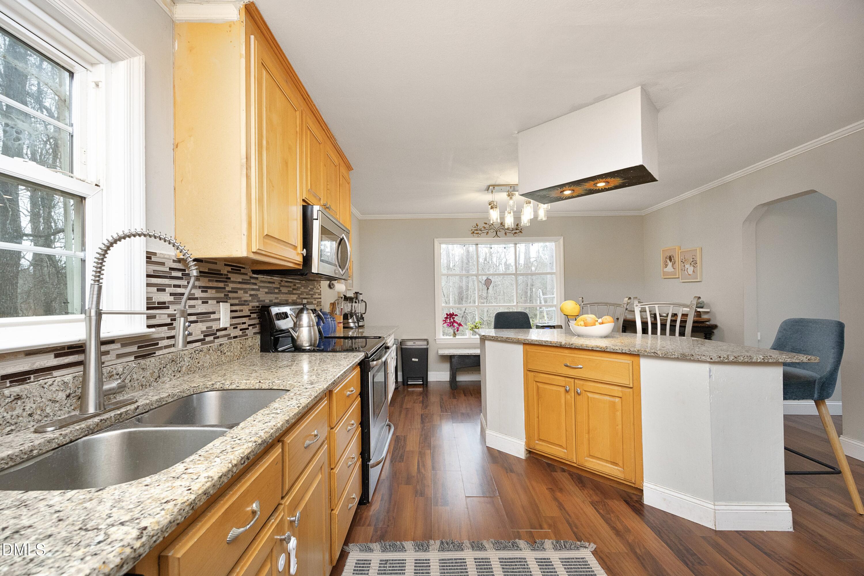 7117 Sunset Lake Road Fuquay-Varina, NC 27526 - Photo 17 of 41 a kitchen with a sink a counter top space and appliances